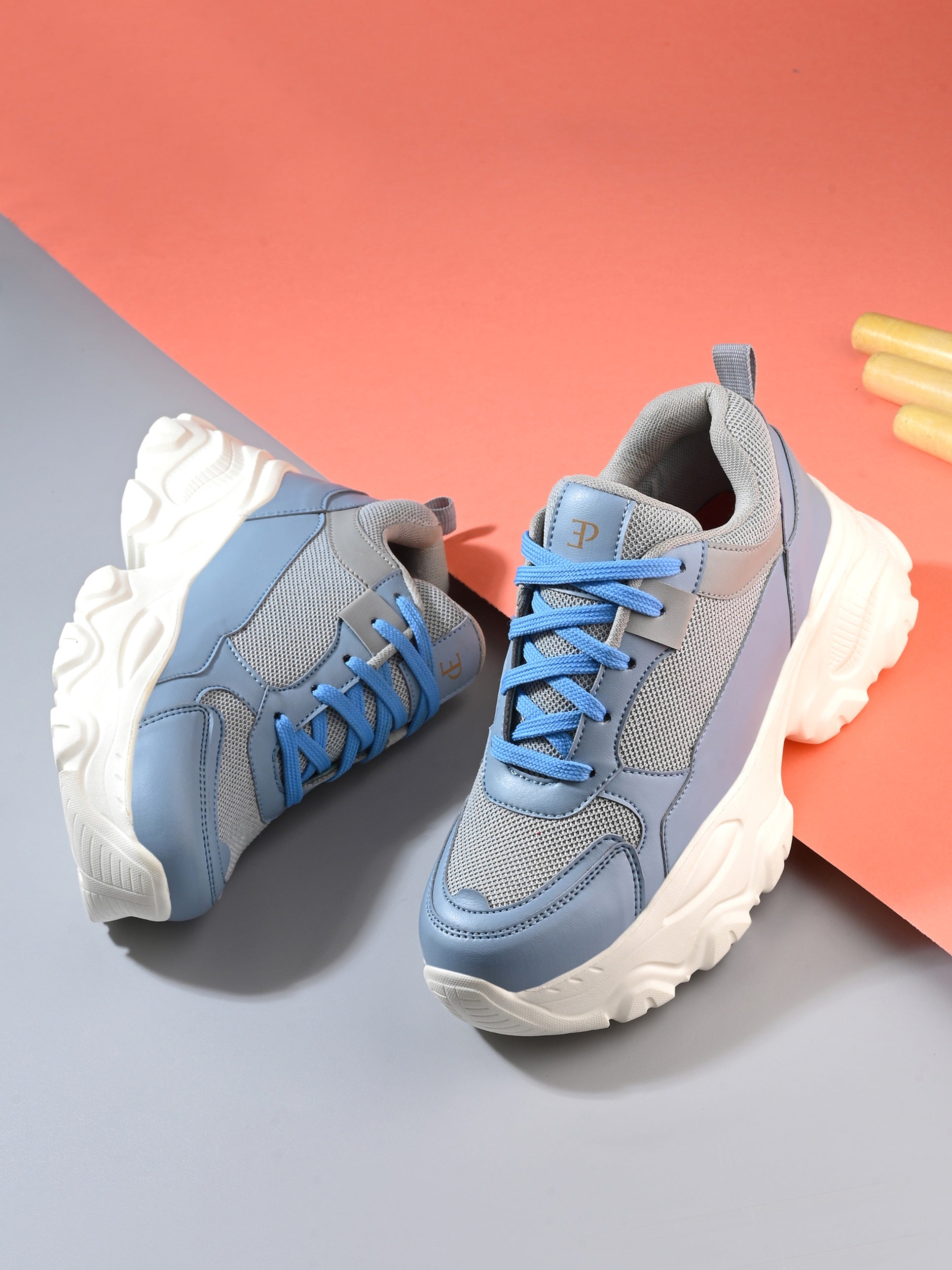 Women Casual Lace Up Sneaker with a gray mesh upper, blue leather panels, blue laces, and a thick white sole.