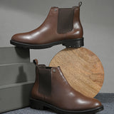 Black leather Classic Chelsea boot with elastic side panels, pull-tab at the heel, rounded toe, and a small metallic brand logo near the ankle.