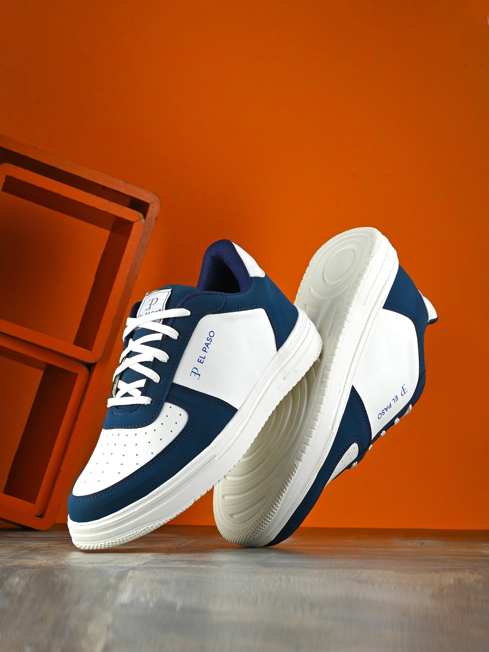 Men Solid Lace-Up Sneakers in white and blue with a sleek design and clean white sole, perfect for casual wear.