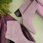 Suede Ankle Boots with a sleek design and block heel, paired with pink Faux Leather Boots for Women.