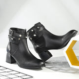 Women Black studded leather ankle boots with studded straps and a buckle design.