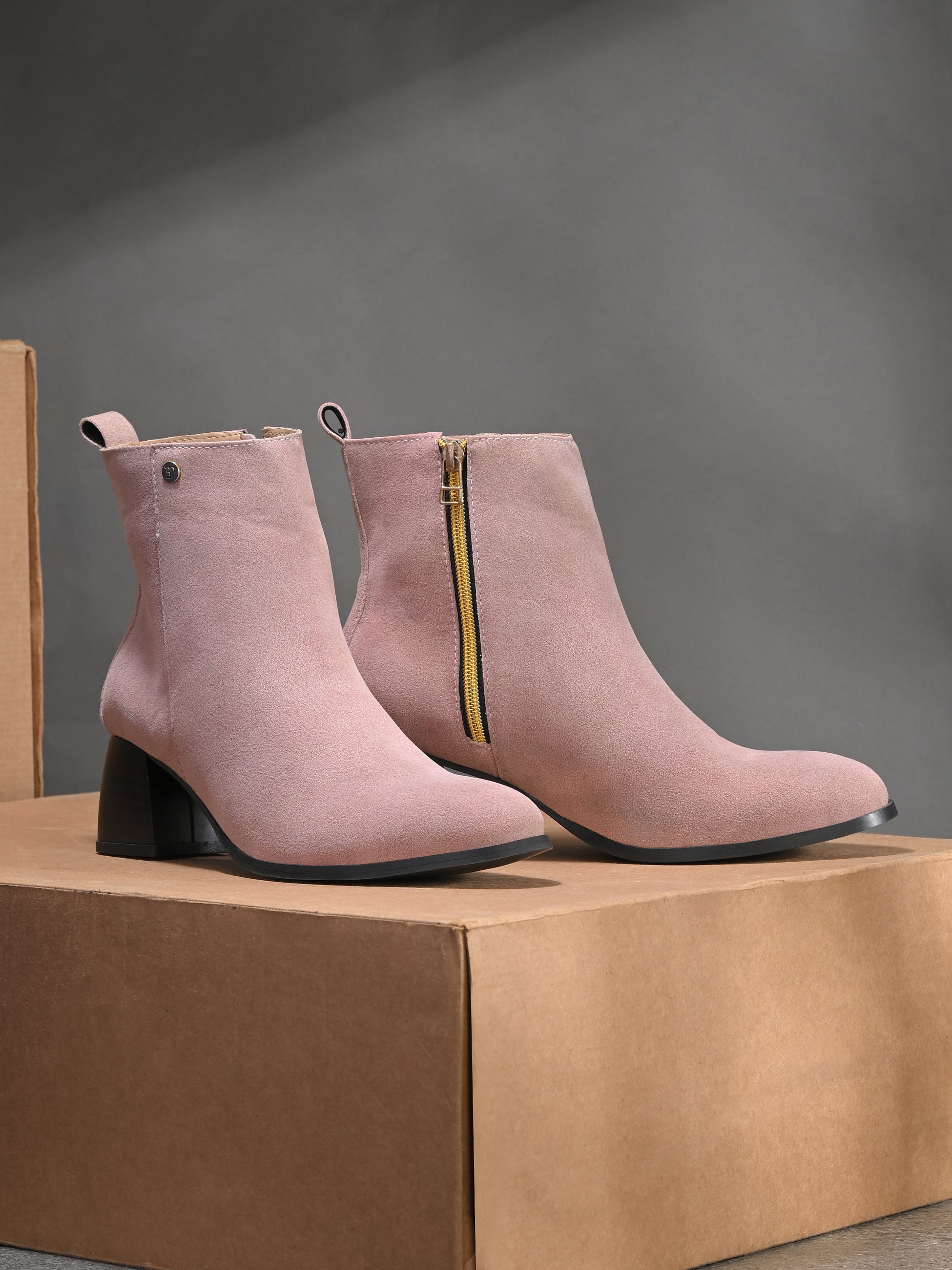 Light pink Suede ankle boots for women with a block heel and a sleek, minimalist design.