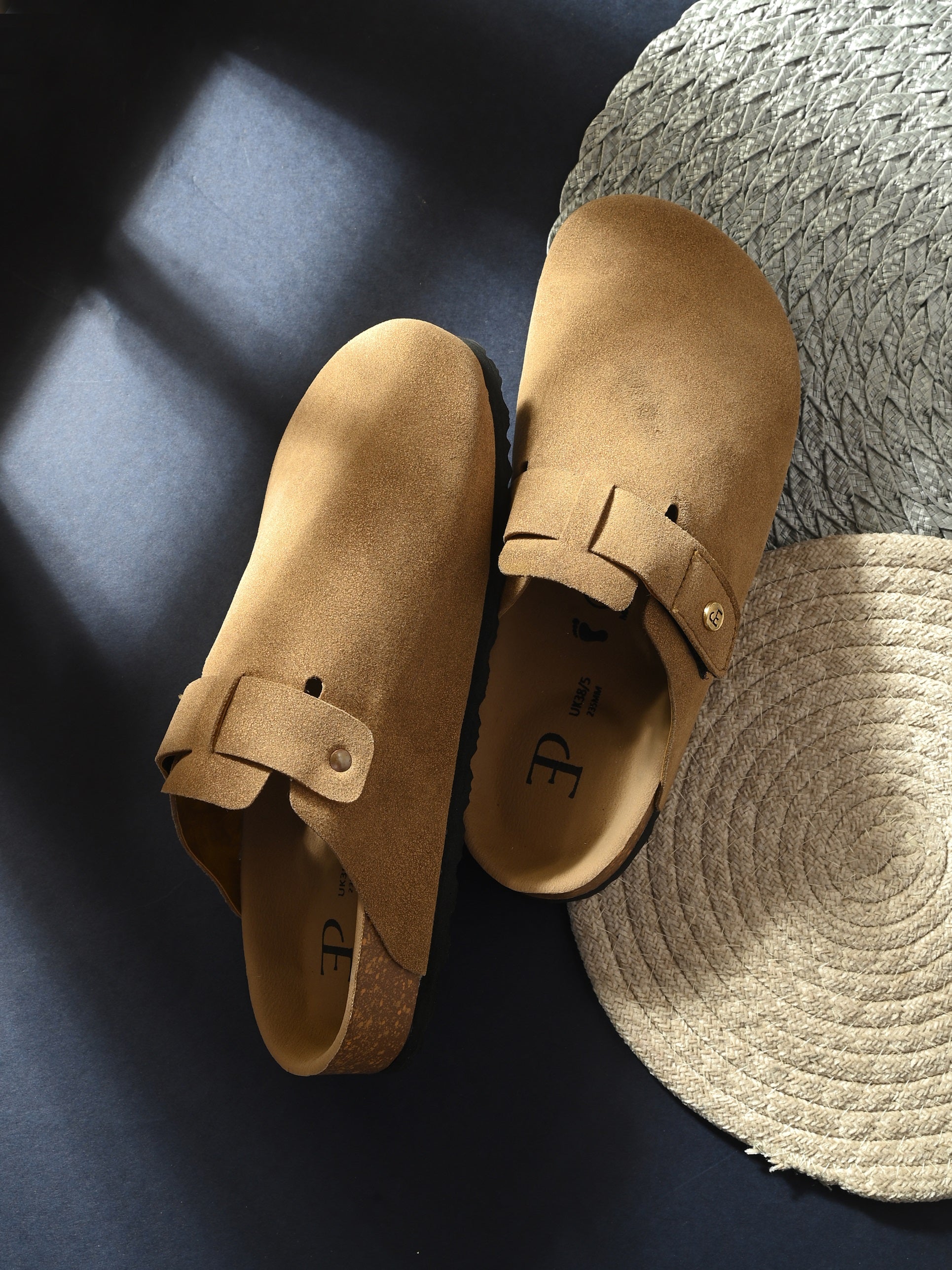 Beige suede slip-on clog with a black rubber sole, adjustable strap, and Boston Soft Footbed for enhanced comfort and support.