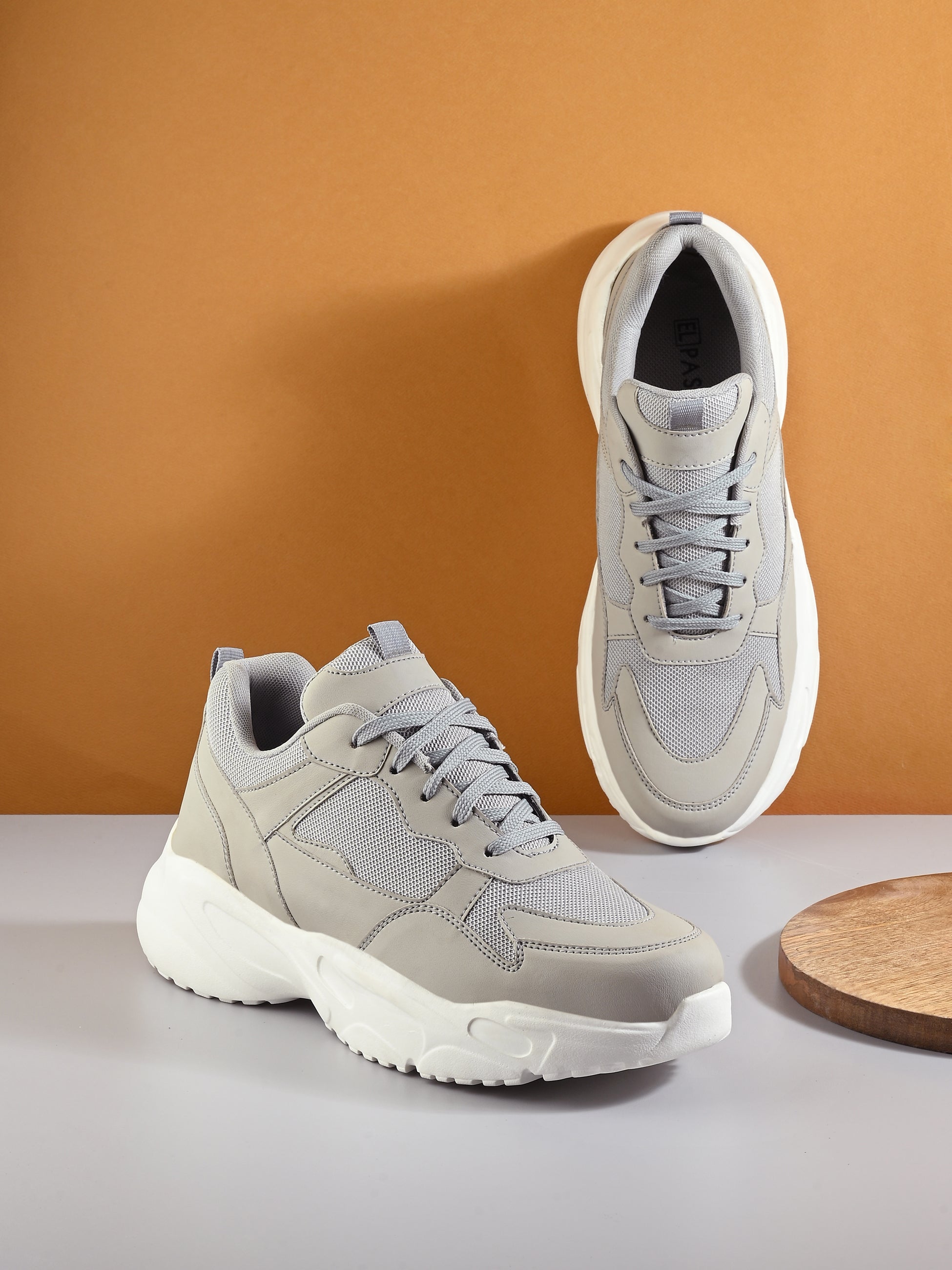 This is a Men grey and white Faux Leather Casual sneaker with a white heel and lace-up design, offering a sleek and modern look.