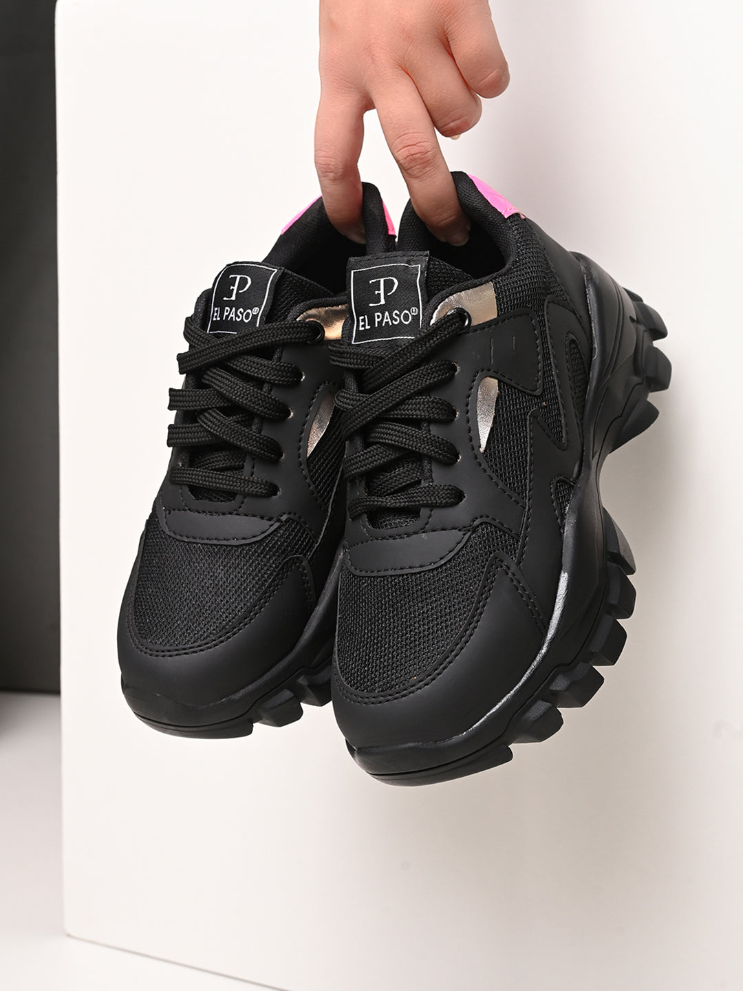 A pair of black El Paso lace-up women's sneakers with chunky soles, mesh detailing, and subtle pink and white accents.