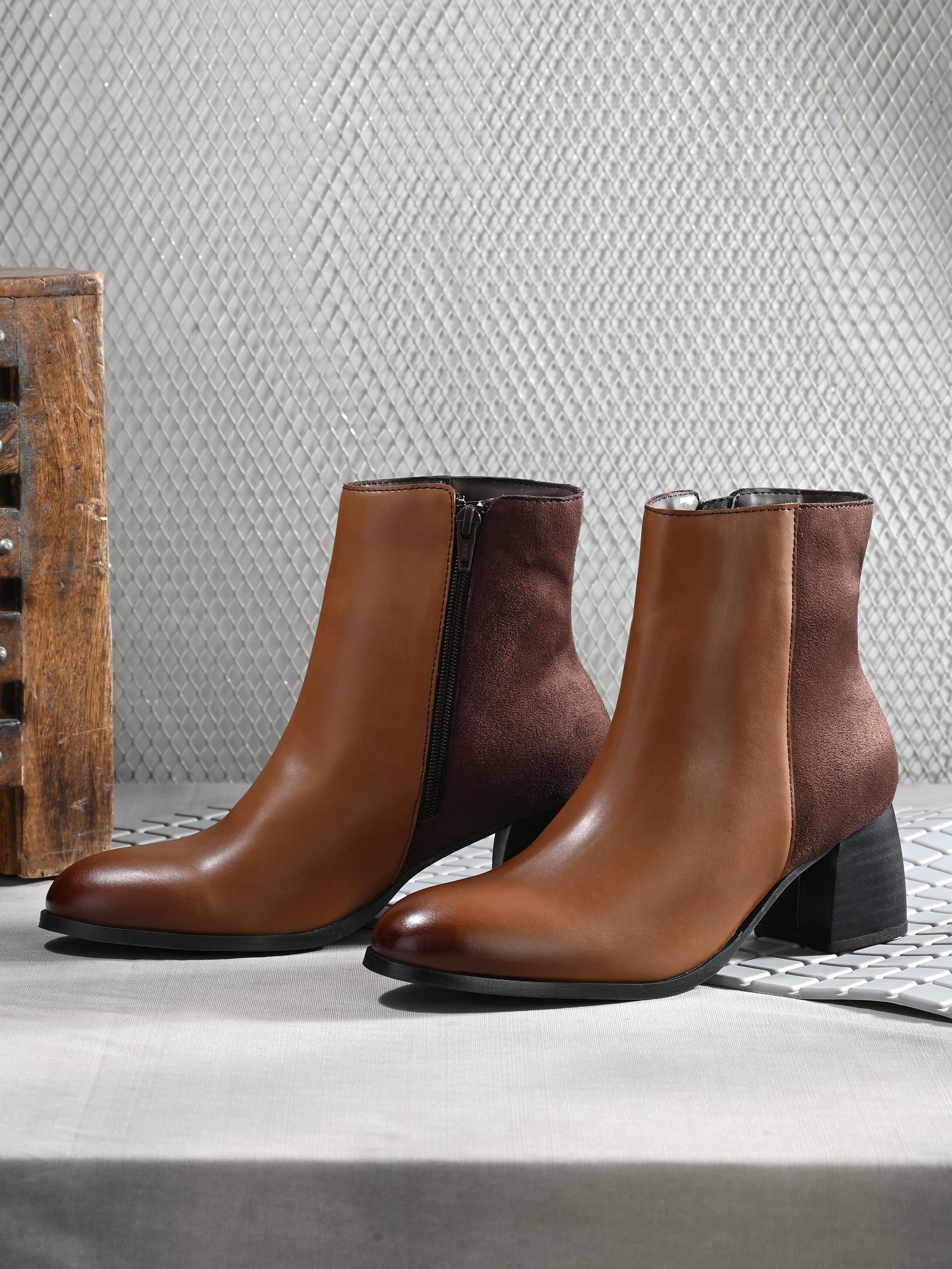 women brown zip ankle length boots with a smooth leather front, suede back, block heel, pointed toe