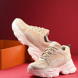 Beige chunky sneakers with a textured sole and mesh accents.