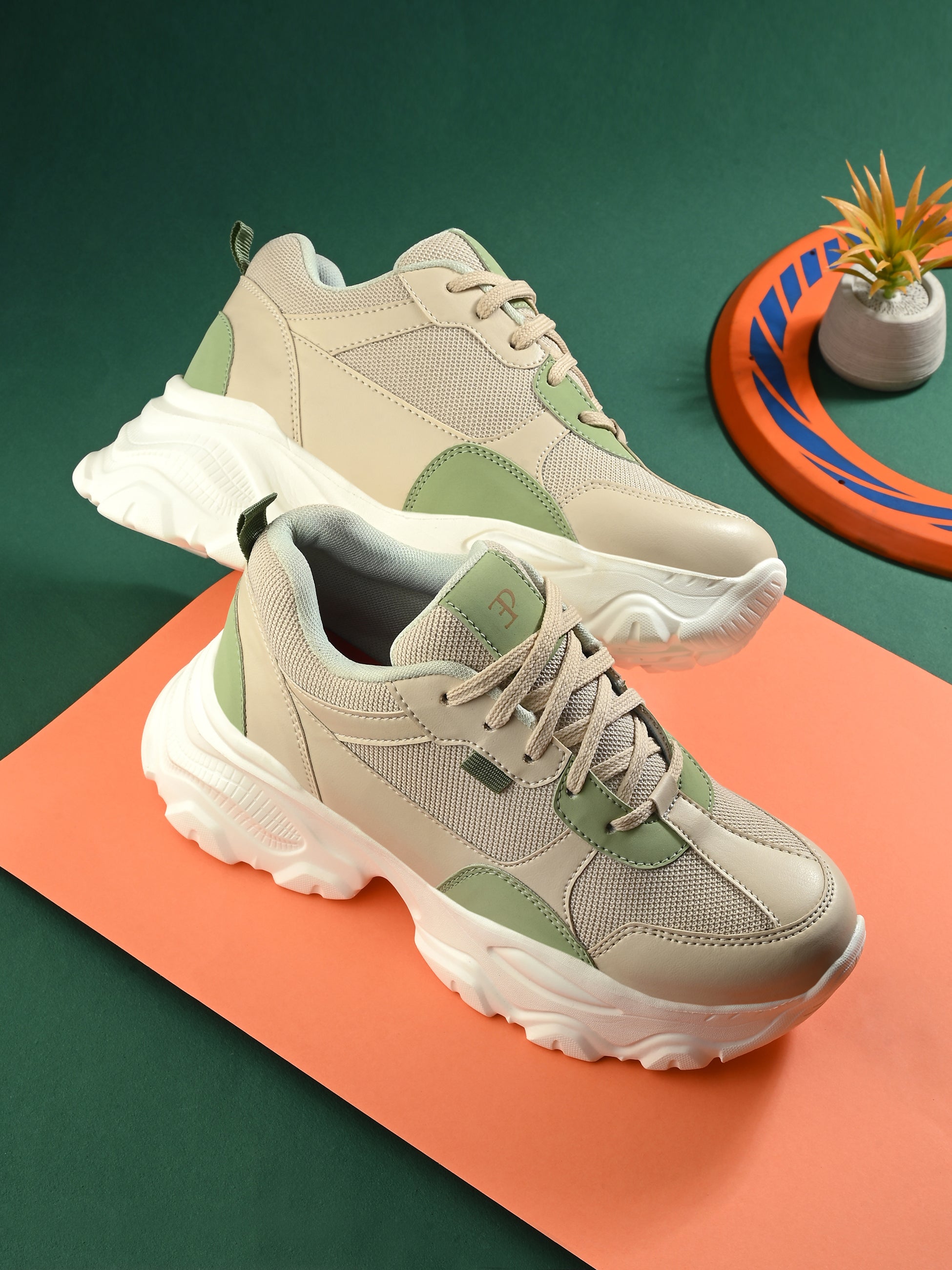 Beige and green chunky casual sneakers for women with a textured sole and modern design.