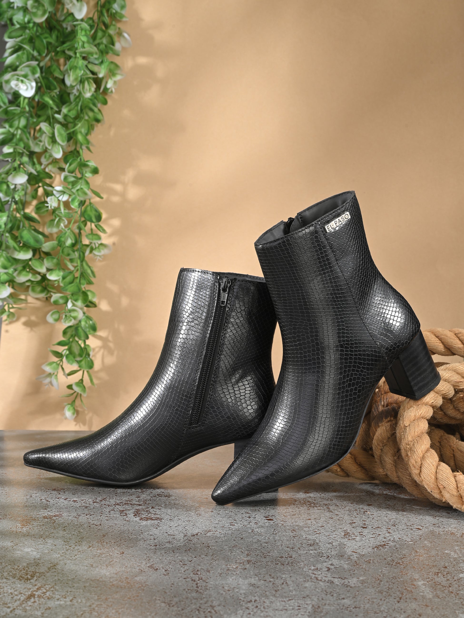 Black textured ankle boots with a sleek snakeskin pattern and a block heel design