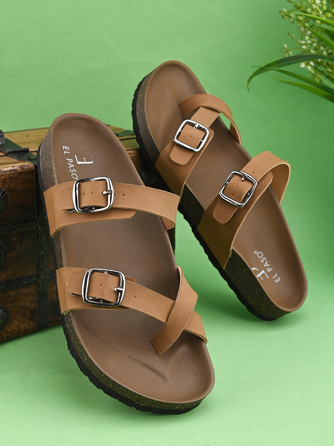 Women’s one-toe flats with a cork sole, silver buckles, and a casual slip-on design.