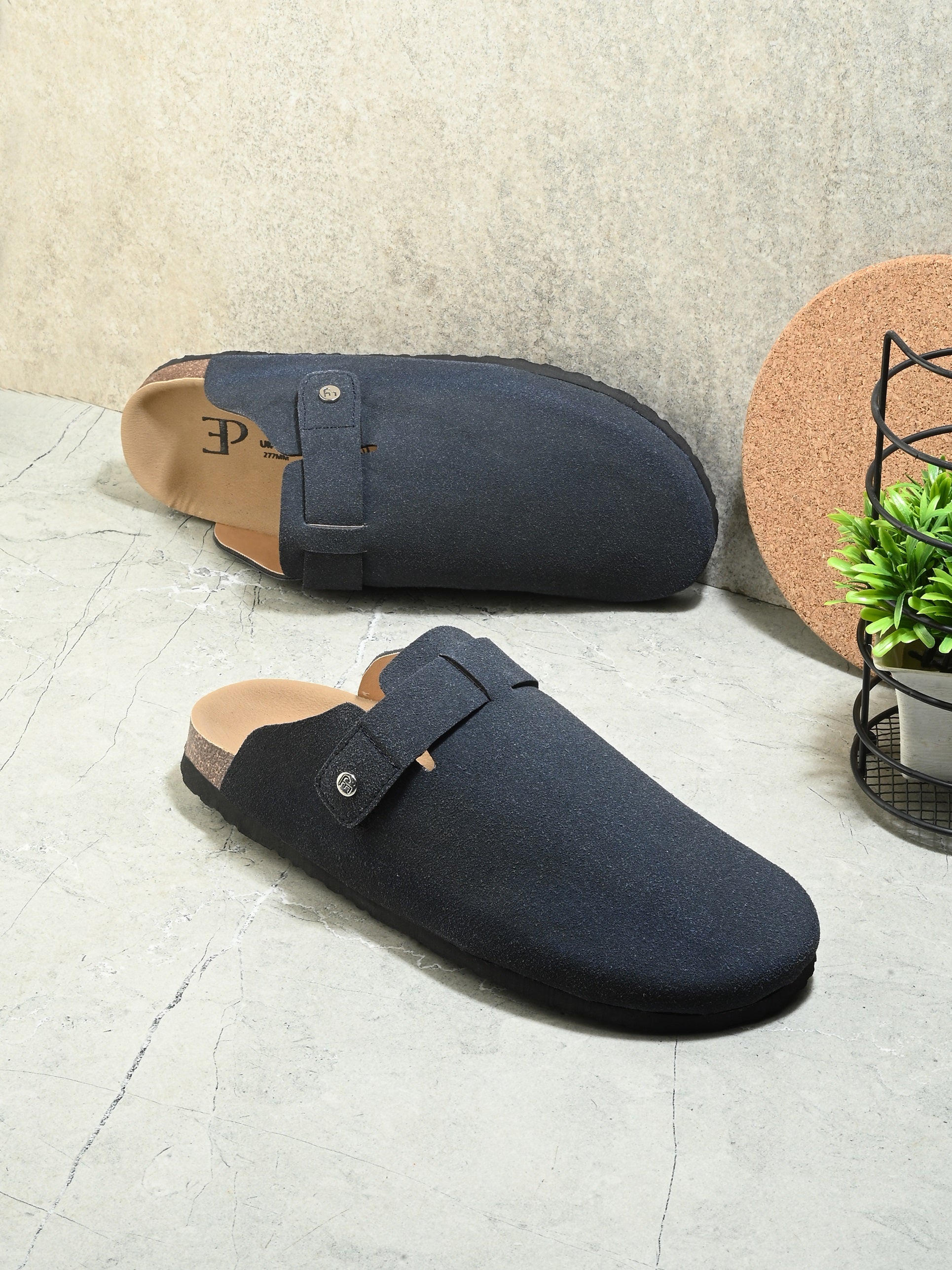 Blue suede slip-on clog with a black rubber sole, adjustable strap, and Boston Soft Footbed for enhanced comfort and support.
