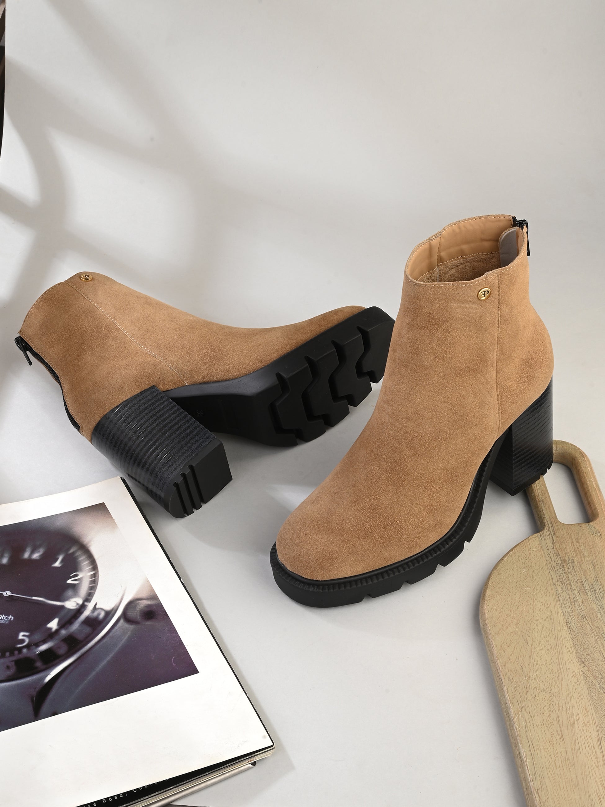 Glossy camel patent leather zip-closure ankle boot with a chunky block heel, lug sole, and a gold logo detail near the collar.