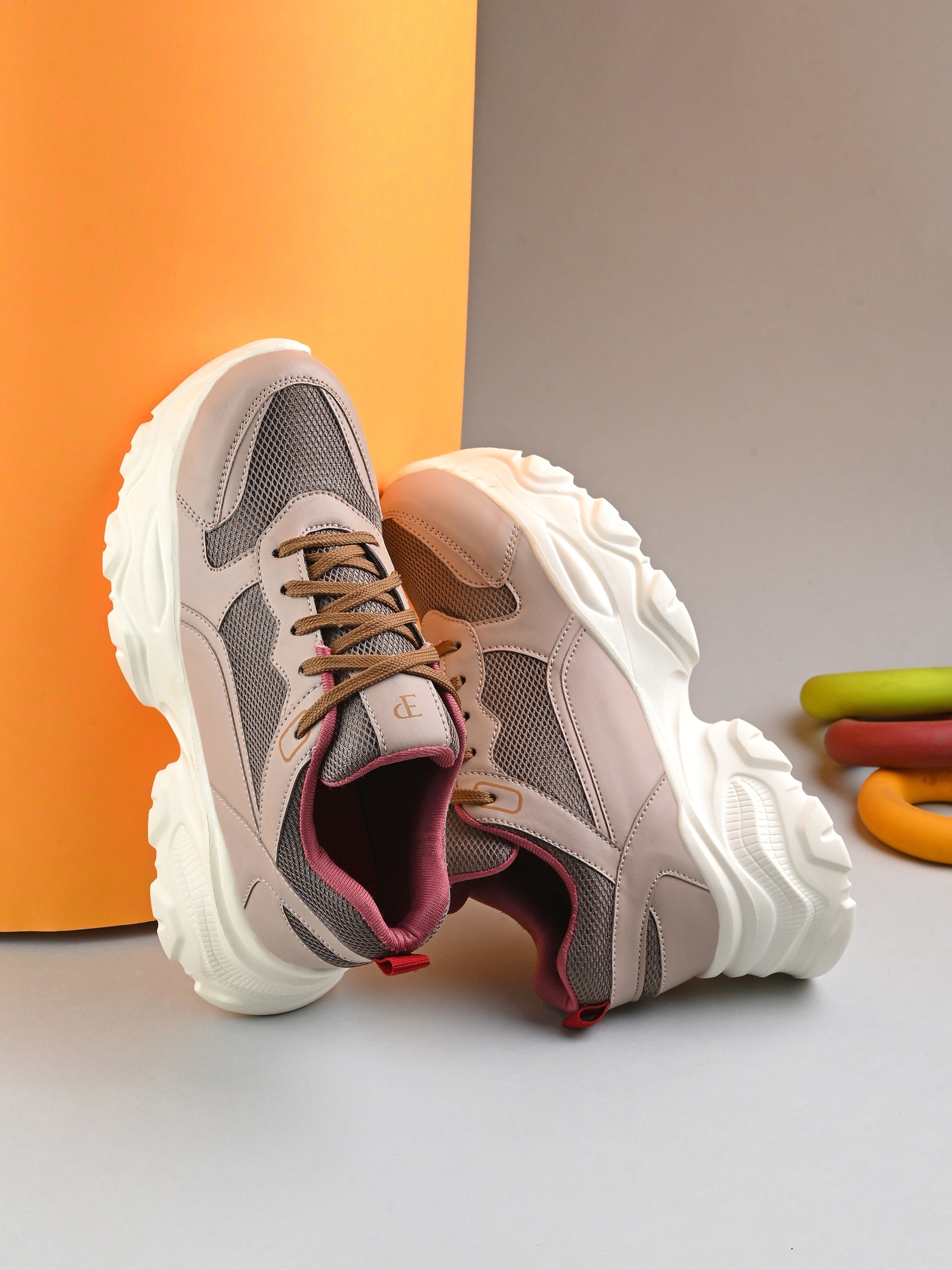Women Casual Lace Up Sneaker with a brown mesh upper, pink leather panels, brown laces, and a thick white sole.