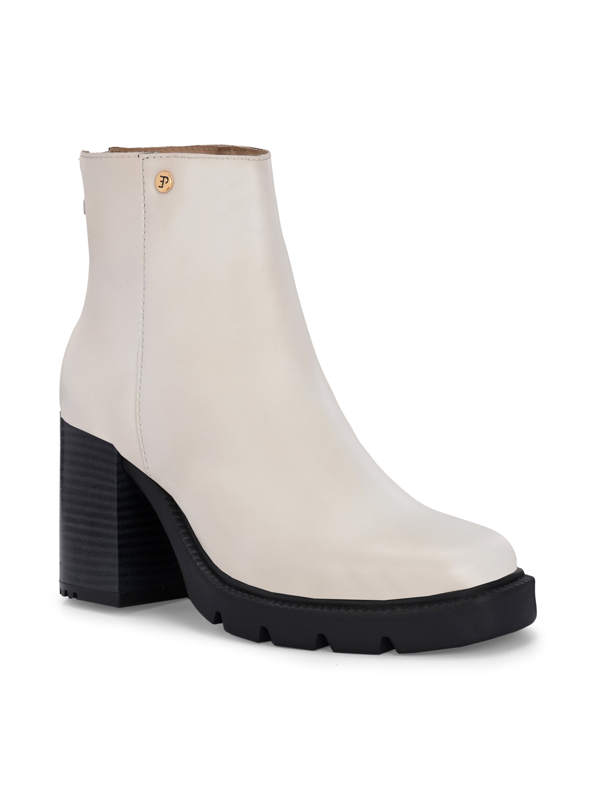 Glossy beige patent leather ankle boot with a chunky block heel, lug sole, and a gold logo detail near the collar.