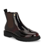 A glossy burgundy Chelsea boot with brogue detailing, elastic side panels, and a durable black sole, featuring a gold accent logo.
