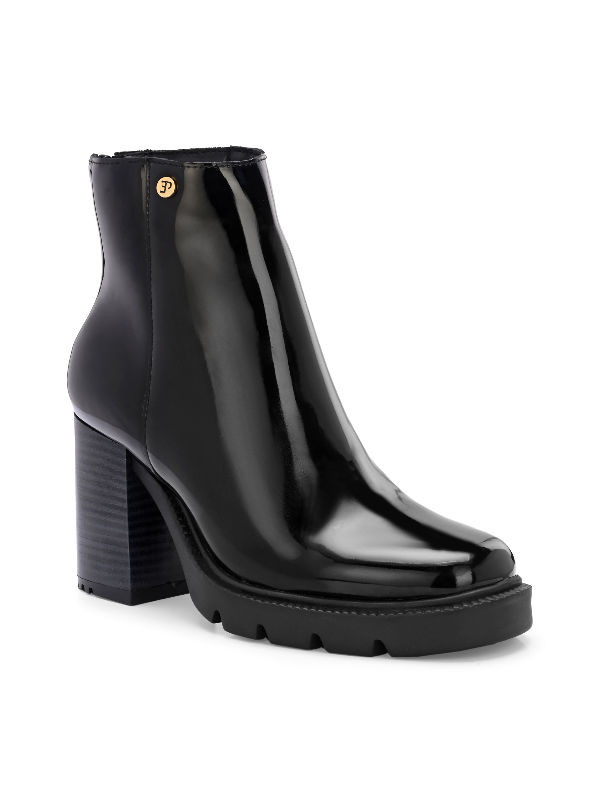 Glossy black patent leather ankle boot with a chunky block heel, lug sole, and a gold logo detail near the collar.