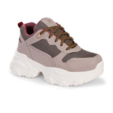 A chunky sneaker with a brown mesh upper, pink leather panels, brown laces, and a thick white sole.
