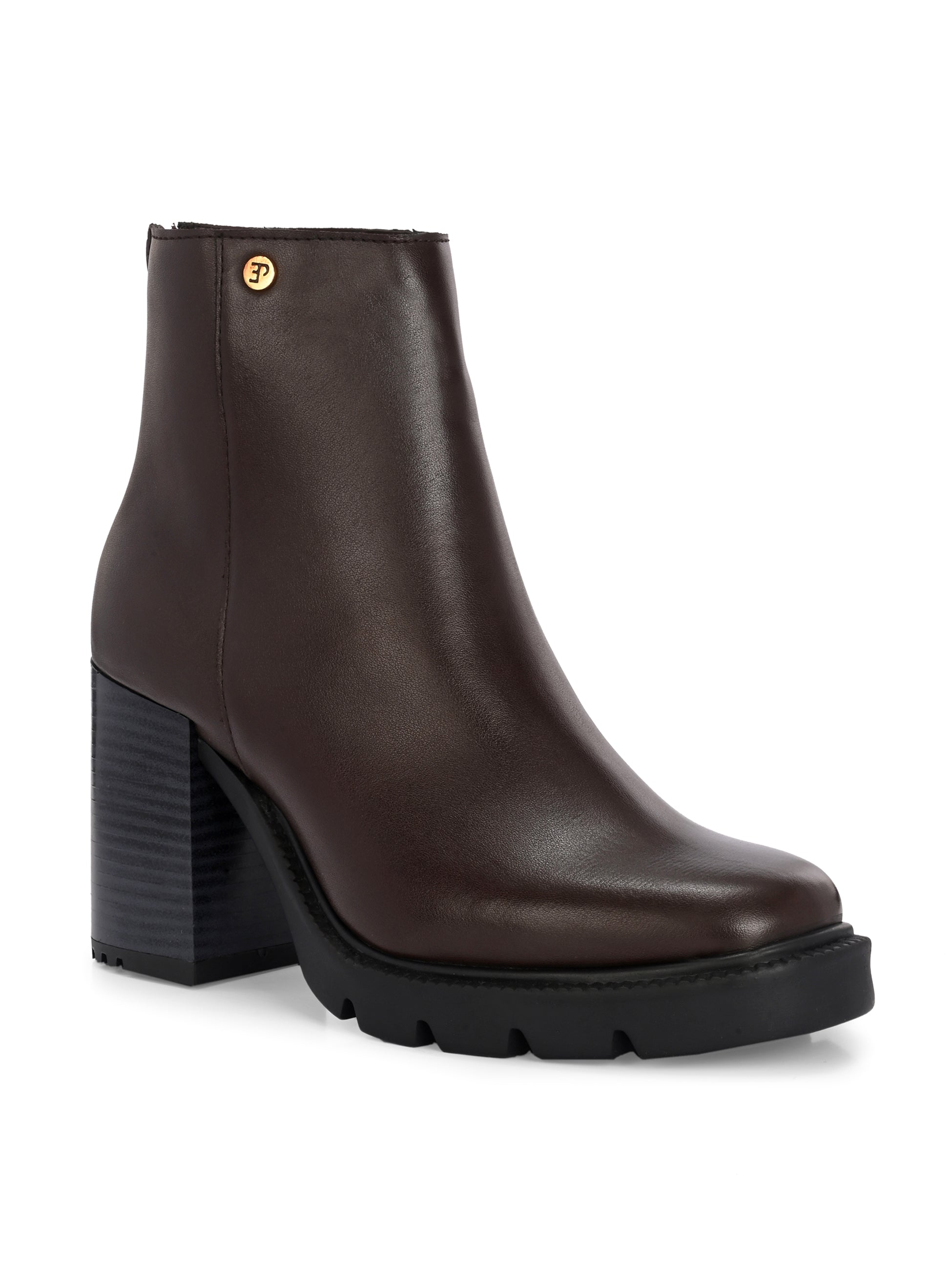 Glossy brown patent leather ankle boot with a chunky block heel, lug sole, and a gold logo detail near the collar.