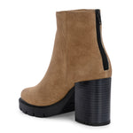 Glossy camel patent leather ankle boot with a chunky block heel, lug sole, and a gold logo detail near the collar.