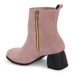 Light pink heigh top boot with a block heel and a sleek, minimalist design.