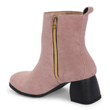 Light pink heigh top boot with a block heel and a sleek, minimalist design.