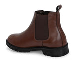 Brown Chelsea boots with elastic side panels, a pull-tab at the heel, rounded toe, and a small metallic brand logo near the ankle.