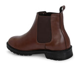 Brown Chelsea boots with elastic side panels, a pull-tab at the heel, rounded toe, and a small metallic brand logo near the ankle.