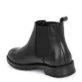 Classic Chelsea boots with elastic side panels, a pull-tab at the heel, rounded toe, and a small metallic brand logo near the ankle.