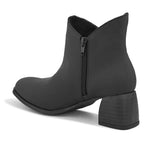 Black ankle boots with a block heel and a sleek gold accent.