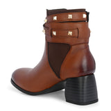 Brown leather ankle boots with studded straps and a buckle design.