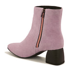 Light pink suede ankle boots with a sleek design and block heel.