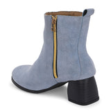 Light blue heigh top boot with a block heel and a sleek, minimalist design.
