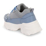 A chunky sneaker with a gray mesh upper, blue leather panels, blue laces, and a thick white sole.