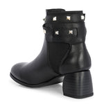 Black leather ankle boots with studded straps and a buckle design.