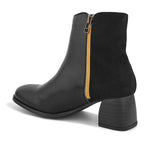 Black ankle boot with a smooth leather front, suede back, block heel, pointed toe with a zip