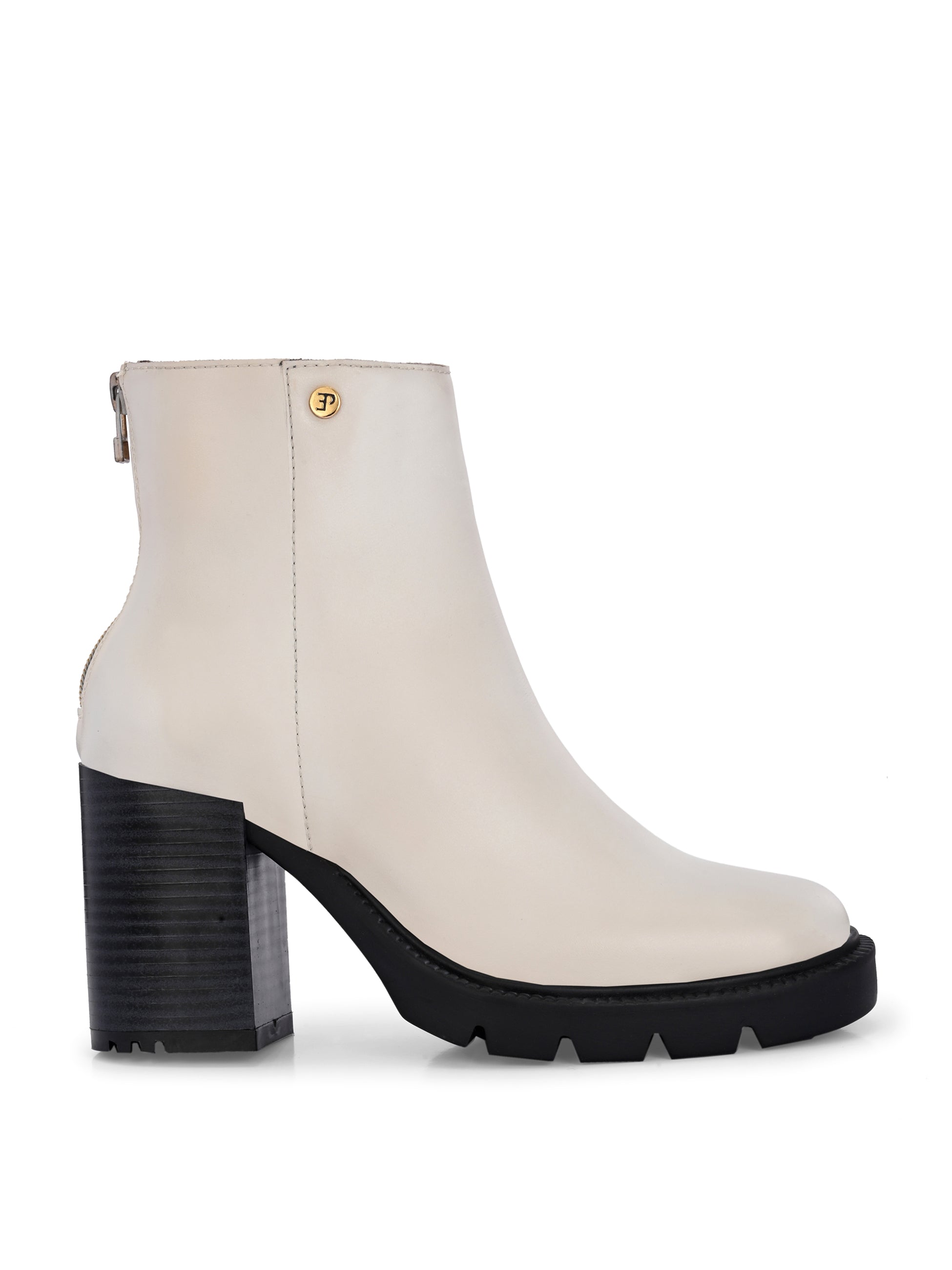 Glossy beige patent leather ankle boot with a chunky block heel, lug sole, and a gold logo detail near the collar.