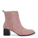 Light pink heigh top boot with a block heel and a sleek, minimalist design.