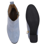 Light blue heigh top boot with a block heel and a sleek, minimalist design.