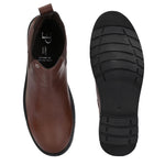 Brown Chelsea boots with elastic side panels, a pull-tab at the heel, rounded toe, and a small metallic brand logo near the ankle.