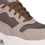 A chunky sneaker with a brown mesh upper, pink leather panels, brown laces, and a thick white sole.