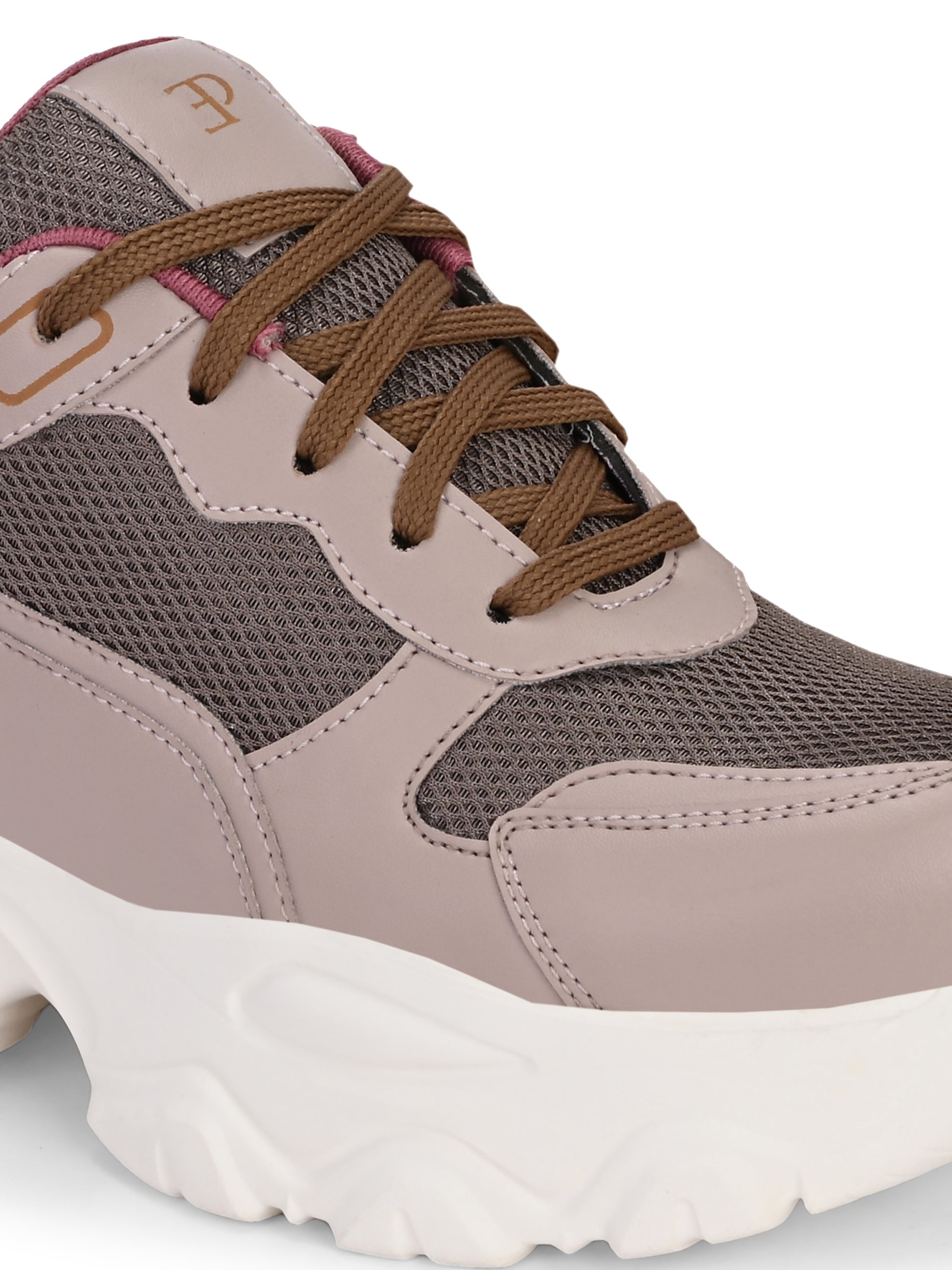 A chunky sneaker with a brown mesh upper, pink leather panels, brown laces, and a thick white sole.
