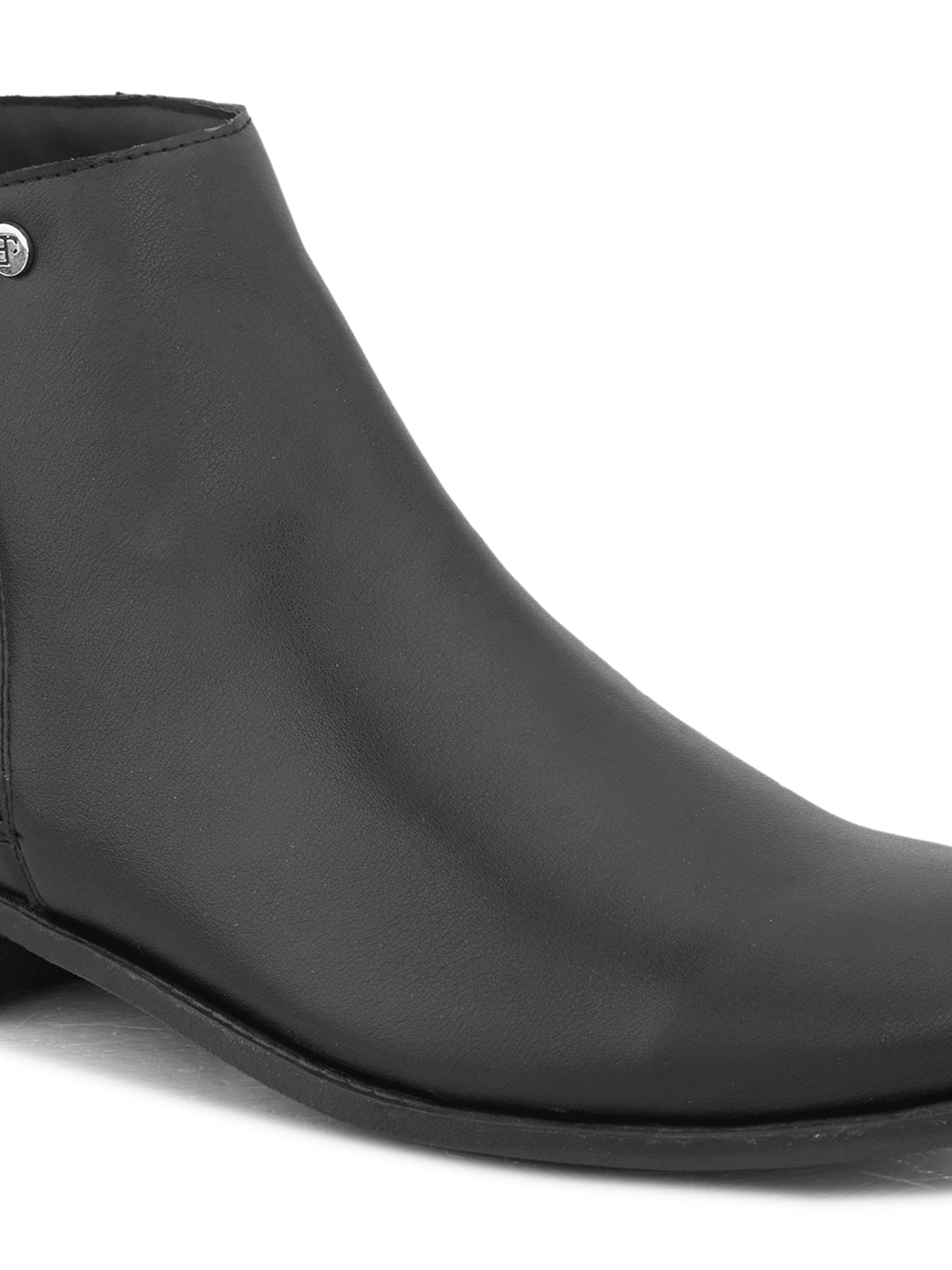 A sleek black leather Chelsea boot with a side zipper, pull-tab at the back, and a low block heel.