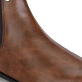 A sleek brown leather boot with elastic side panels, pull tab, low stacked heel, and a polished finish for a versatile look.