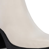 Glossy beige patent leather ankle boot with a chunky block heel, lug sole, and a gold logo detail near the collar.