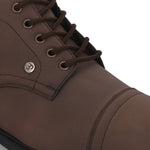Faux leather casual boots with a cap toe, sleek design, metal eyelets, and a small brand logo near the ankle.