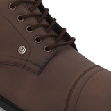 Faux leather casual boots with a cap toe, sleek design, metal eyelets, and a small brand logo near the ankle.