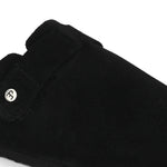Black suede slip-on clog with a black rubber sole and adjustable strap.