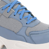 A chunky sneaker with a gray mesh upper, blue leather panels, blue laces, and a thick white sole.