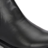 Classic Chelsea boots with elastic side panels, a pull-tab at the heel, rounded toe, and a small metallic brand logo near the ankle.
