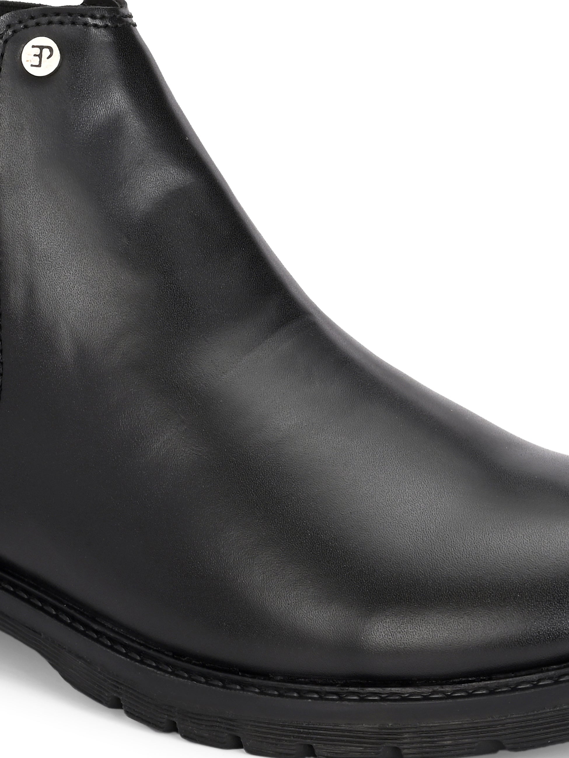 Classic Chelsea boots with elastic side panels, a pull-tab at the heel, rounded toe, and a small metallic brand logo near the ankle.
